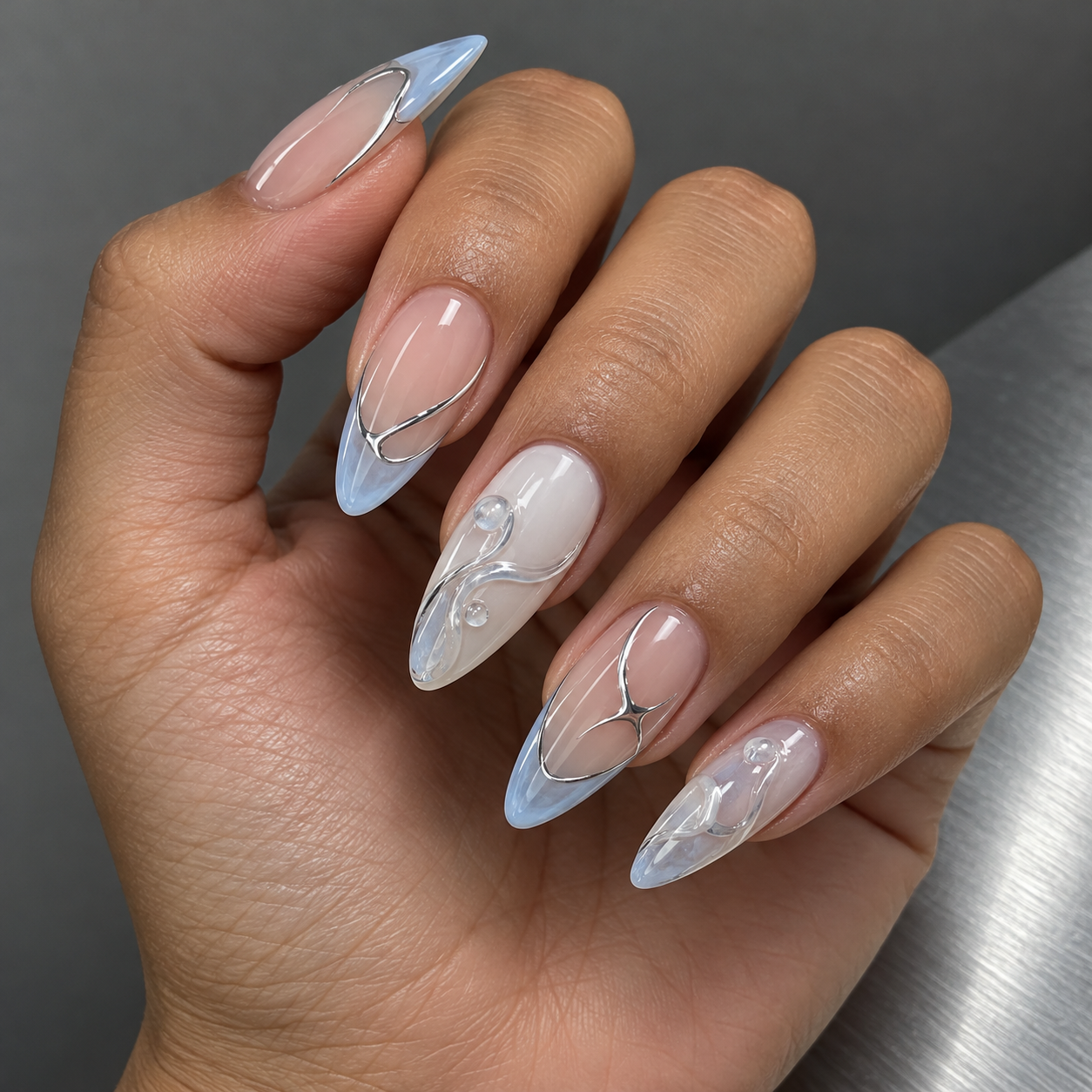Ice-blue glass tips and silver details manicure inspiration